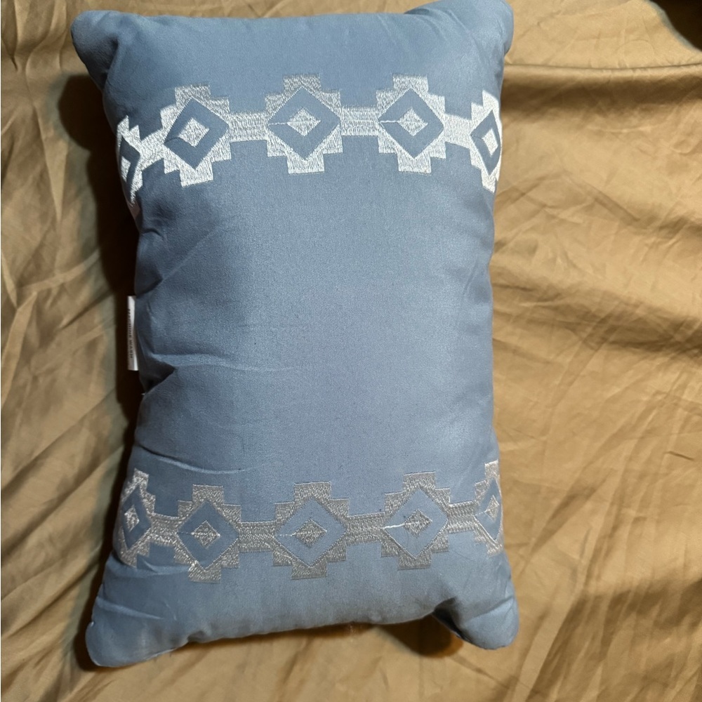 NWOT throw pillow. Muted blue color w/ silver embroidery
